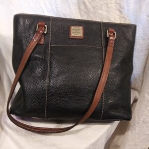 Sturdy leather tote. Back with brown accents.